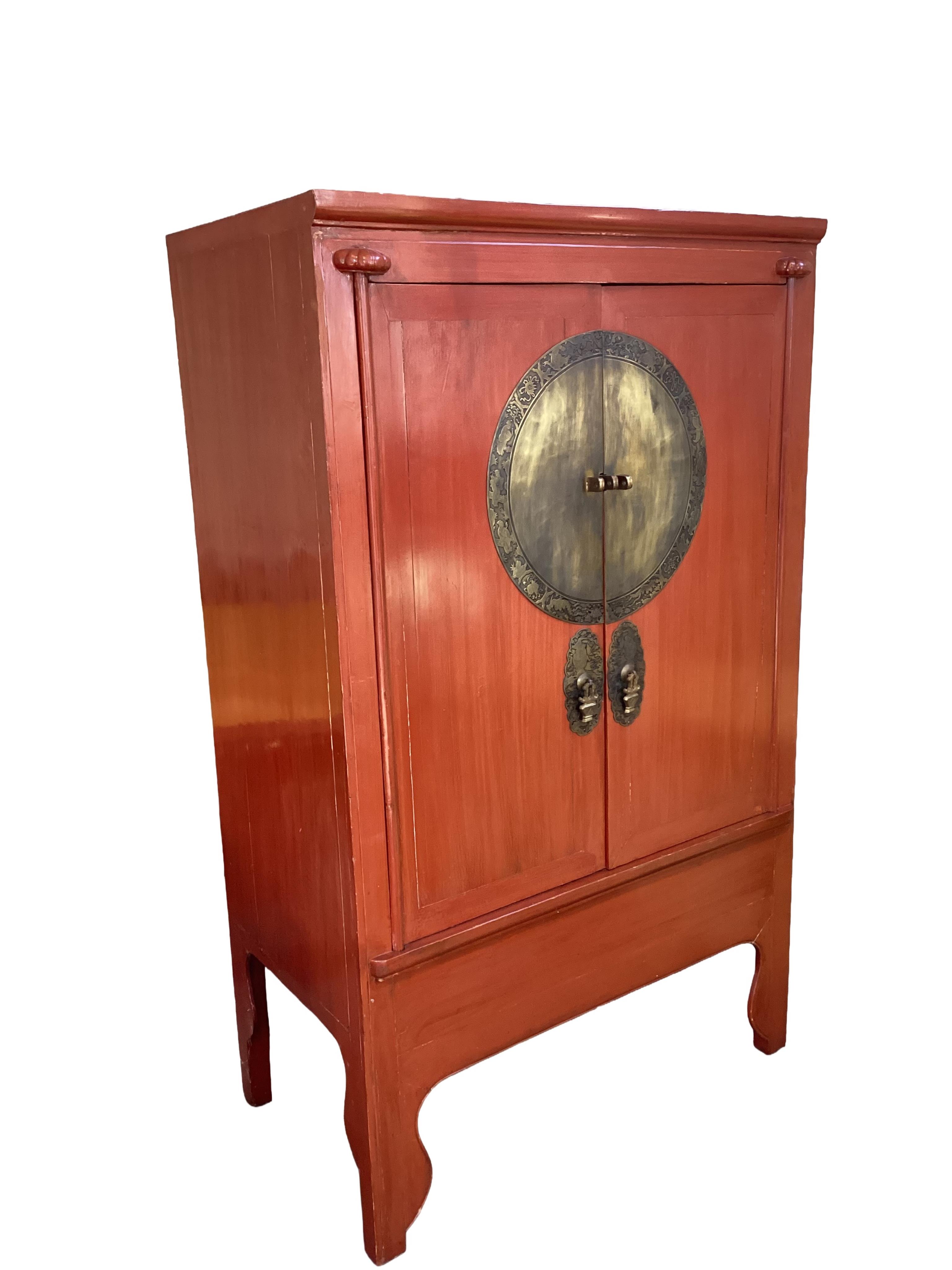 A Chinese brass mounted red lacquer cabinet, width 110cm, depth 60cm, height 186cm